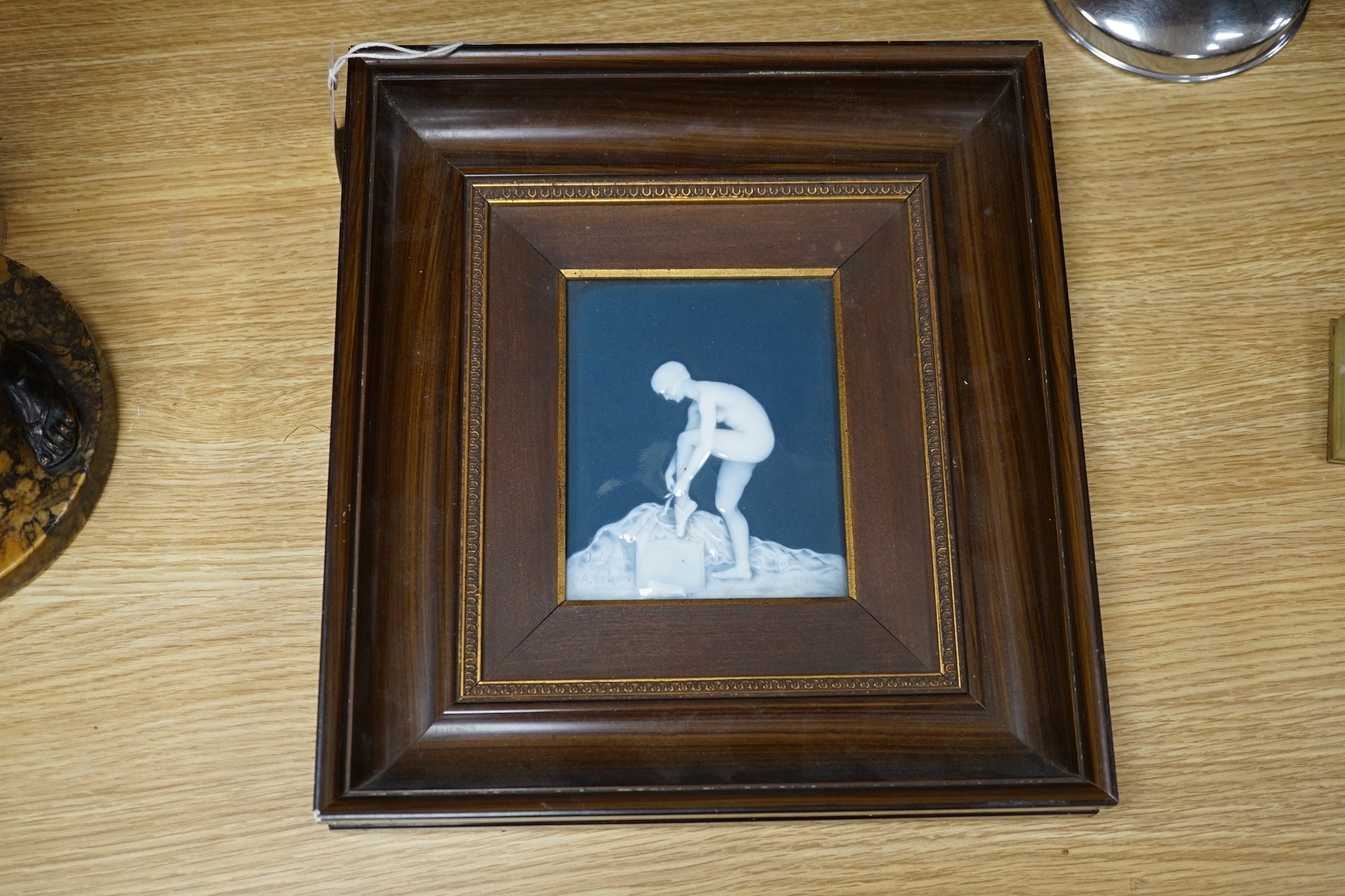 A framed Limoges pate sur pate plaque, after A. Leroux, depicting a ballet dancer undressing, plaque 14 cm X 11.5 cm